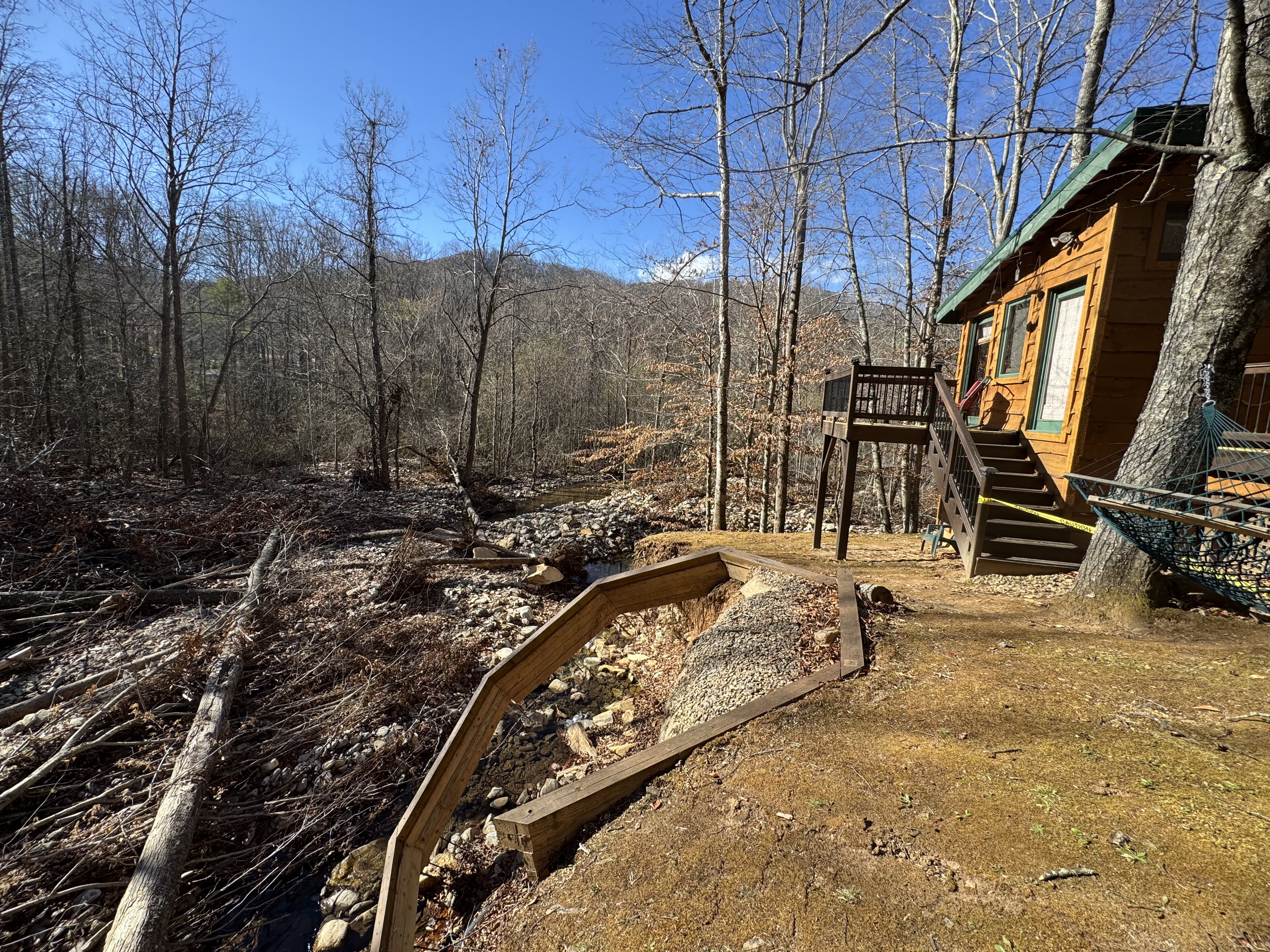Handcrafted creekside fire pit with boulder walls